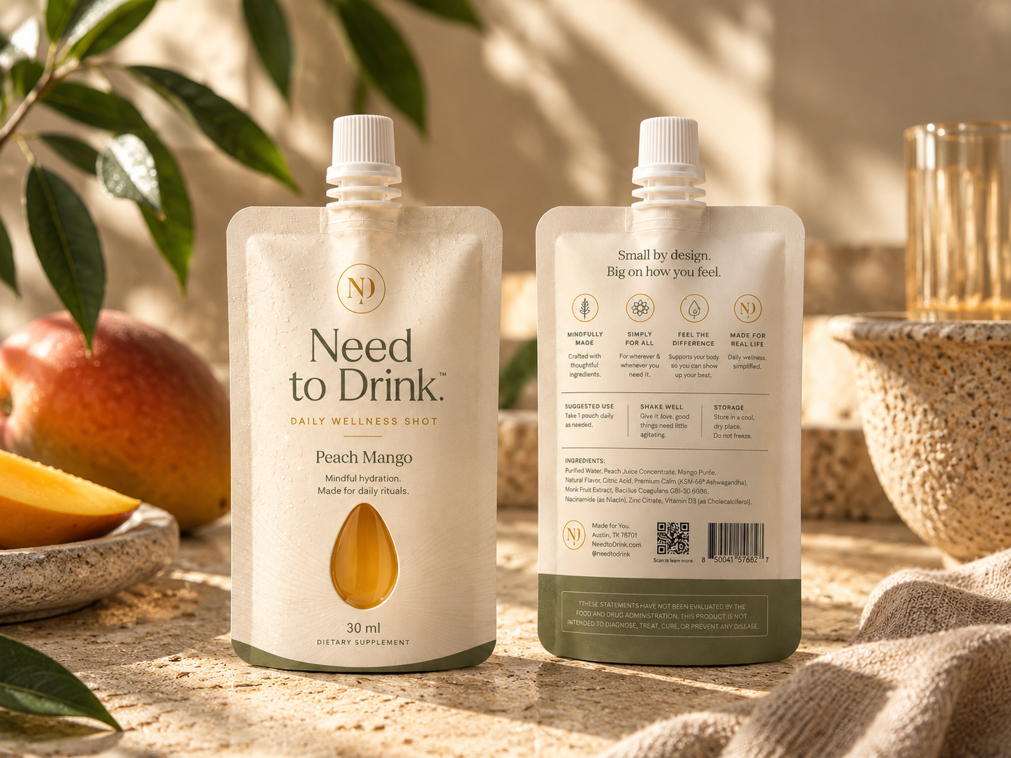 Front and back of the Need to Drink Peach Mango pouch in a warm, naturally lit setting